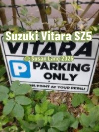 Parking sign for Suzuki Vitara SZ5 with overlaid text “Suzuki Vitara SZ5” and “© Susan Lane 2025” - a cheeky warning to trespassers in leafy surroundings.