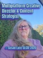 ColourMine author – A woman with long hair and glasses sits outdoors in soft daylight, smiling gently with a hedge and blue sky behind her.